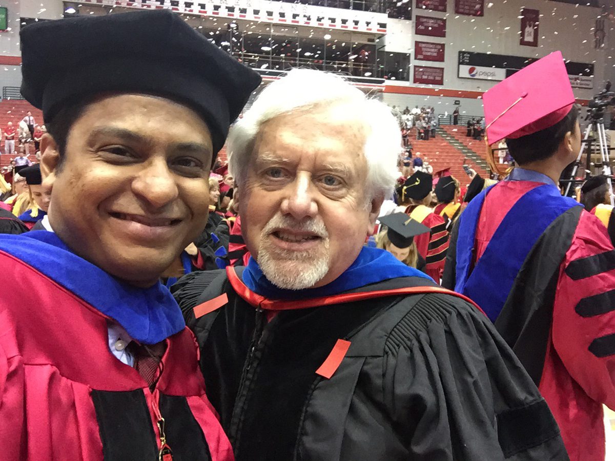 Hasan Pasha in doctoral regalia with his advisor, Dr. Randall J. Allemang, at the University of Cincinnati commencement.